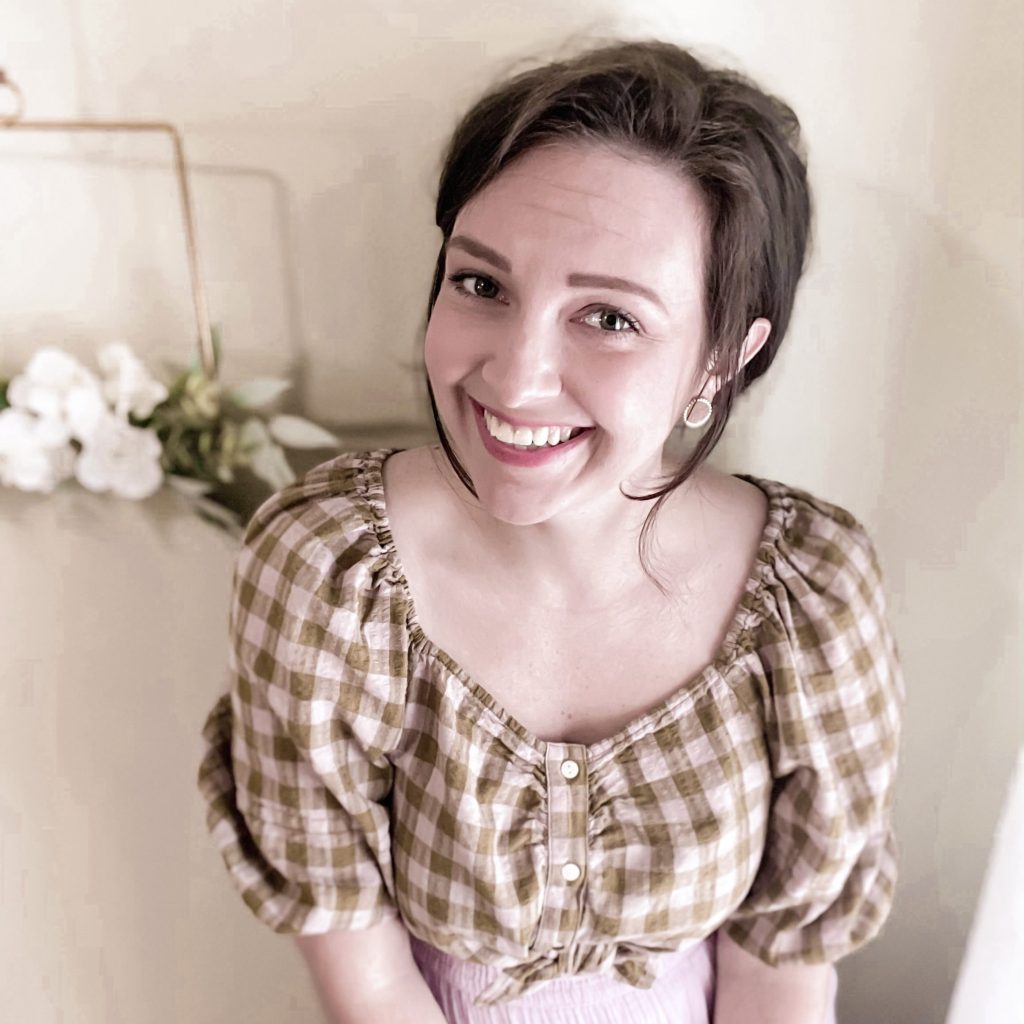 rachel, author of the feminine homemaker. woman with dark hair smiling wearing gingham shirt